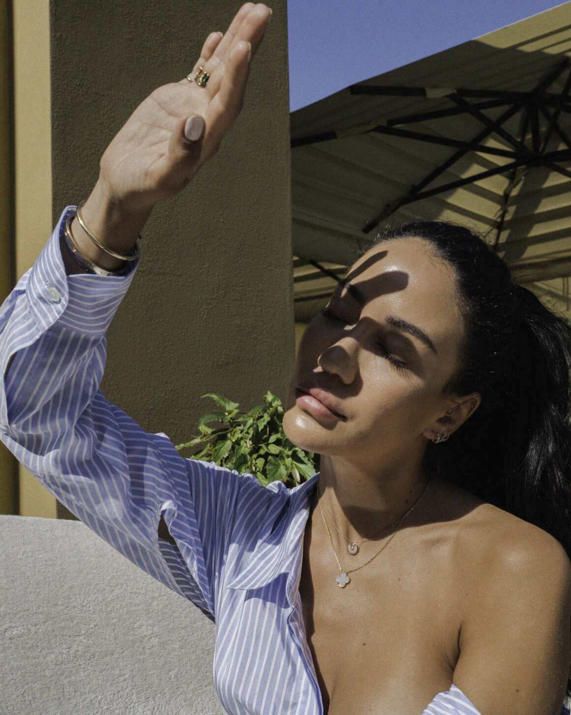Outdoor close up picture with hand covering the sun
